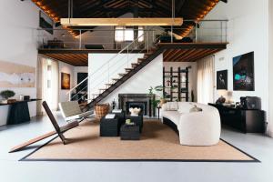 a living room with a couch and a fireplace at Pico do Refúgio - Casas de Campo in Ribeira Grande