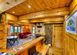 a living room and dining room in a log cabin at Osada Solina in Solina