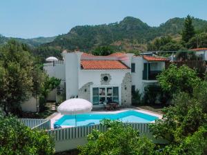 a villa with a swimming pool and a house at Alya Country in Turunc