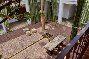 a patio with a table and chairs and a tree at Hotel Azul de Oaxaca in Oaxaca City