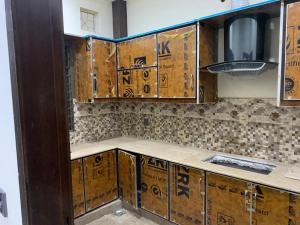 kuchnia z drewnianymi szafkami i blatem w obiekcie Flashyy-The Best for Less w mieście Lahaur
