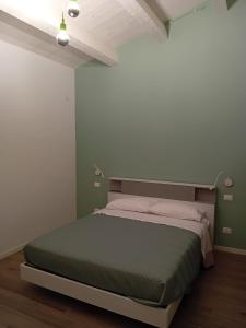 a bedroom with a large bed in a room at B&B il Santo in Castelleone di Suasa