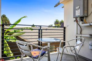 a patio with two chairs and a table on a balcony at Modern 1-Bedroom Loft in Hollywood with Parking, WiFi & Hollywood Sign View in Los Angeles
