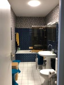 a bathroom with a tub and a sink and a bath tub at Vue Mer Santa Clara 3 in La Baule