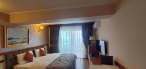Postel nebo postele na pokoji v ubytování Hotel Panorama Dajt