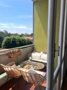 a balcony with two wicker chairs and a table at mirabello in Reggio Emilia