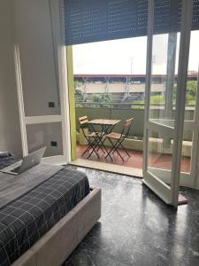 a bedroom with a bed and a table with a laptop at mirabello in Reggio Emilia