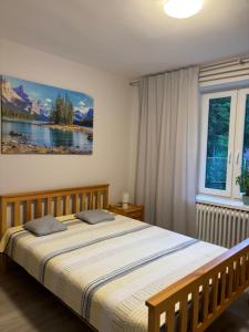 a bedroom with a bed and a painting on the wall at U podnóża Kotarza in Brenna