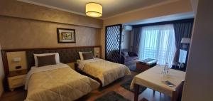 Postel nebo postele na pokoji v ubytování Hotel Panorama Dajt