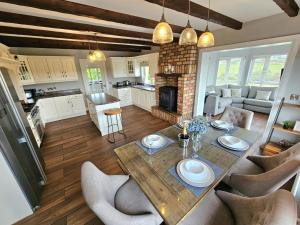 a kitchen and living room with a table and chairs at Brontès House in Dungloe