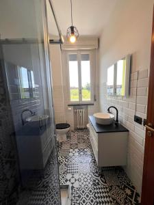 a bathroom with a shower and a sink and a toilet at mirabello in Reggio Emilia