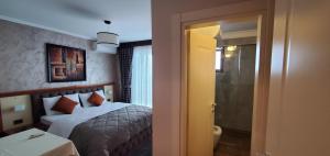 Postel nebo postele na pokoji v ubytování Hotel Panorama Dajt