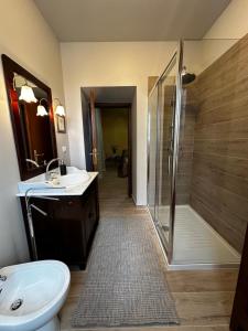 a bathroom with a shower and a toilet and a sink at Historic apartment in Bucine