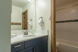 a bathroom with a sink and a mirror at Bridgepoint Condo 30 in Ketchum +24 photos