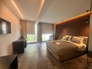 Ένα ή περισσότερα κρεβάτια σε δωμάτιο στο Signature Suites - Athens