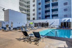 a swimming pool with chairs and a hotel at Diamond Suite at Platinum Hotel in Las Vegas