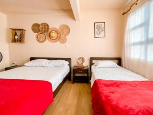 two beds sitting next to each other in a room at La Rosa Nautica Hostel in Guaduas
