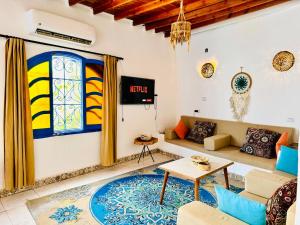 a living room with a couch and a table at Blue Villa in Lighthouse in Dahab