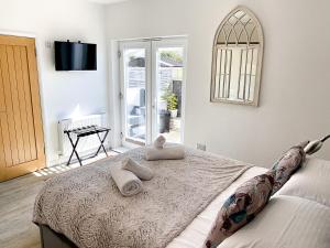 a bedroom with a bed with two pillows on it at Meadow View Apartments are 2 and 3 bedroomed with private parking in Newquay