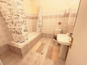 a bathroom with a toilet and a sink and a shower at oLive Home in Alexandroupoli +12 photos