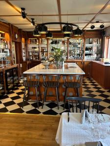 a restaurant with a table and chairs and a checkered floor at Villa Solviken in Lysekil