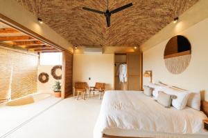 a bedroom with a large bed and a bathroom at Casa Borka LUXURY FULLY FURNISHED BEACH CONDOS WITH POOL in Puerto Escondido +75 photos