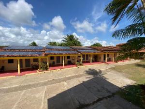 a building with solar panels on the roof at Guará Praia Hotel in Salinópolis
