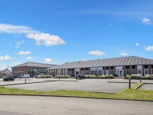 a large building with a parking lot in front of it at 4 person holiday home in Fanø in Fanø