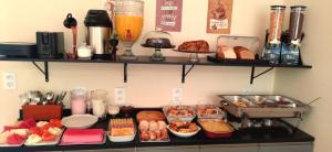 a buffet of food on a counter in a kitchen at Pousada Perola da Praia in Penha