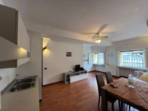 a kitchen and living room with a table and a dining room at Casa Nostra in Bellagio