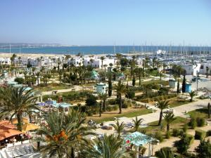 a view of a resort with palm trees and a harbor at Appartement marina hammamet in Yasmine