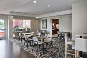 a restaurant with tables and chairs in a room at Residence Inn Atlanta NE/Duluth Sugarloaf in Duluth