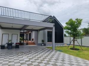 a house with a checkered floor at P2 Location pool villa in Ban Pak Chong