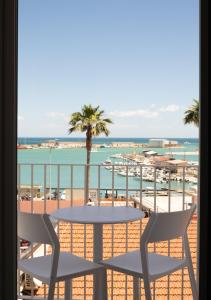 a table and chairs on a balcony overlooking the beach at SAVANTO in Termoli