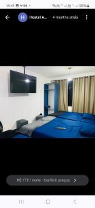 a picture of a bedroom with a bed and a tv at Hostel Anprado 7 kit café incluso, Próx-Aeroporto de Guarulhos in Guarulhos