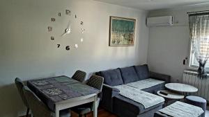 a living room with a couch and a table at Istocno Sarajevo, Lukavica, Great View Apartment in Donje Mladice