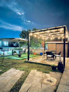 a pavilion with a table in a backyard at Pastora House Luxe Staycation Bauan Batangas in Bauan +37 photos