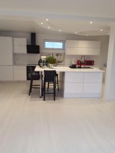 a kitchen with white cabinets and a table and chairs at Not Taking Guests in Eide