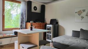 a small living room with a table and a couch at Seßles Waldhäusschen Dietzhausen in Suhl