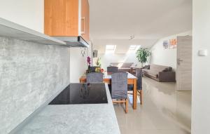 a kitchen and living room with a counter and a table at Cozy Apartment In Dobrzyca With Wifi in Dobrzyca