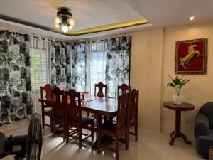a dining room with a table and chairs at The Downtown Cabin Bohol in Tagbilaran City