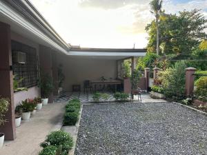 a patio with a table and some plants at The Downtown Cabin Bohol in Tagbilaran City