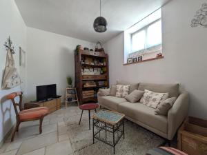 a living room with a couch and a tv at Maison de village à 200m de la plage à Collioure - FR-1-309-464 in Collioure