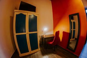 a room with a cabinet and a table and a mirror at GRAN ALCÁZAR HOTEL BOUTIQUE in San Luis Potosí