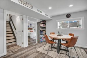 a dining room with a table and chairs and a bedroom at Saskatoon 5 bedroom-Big Gatherings-Patio-BBQ-Games Room in Saskatoon +36 photos