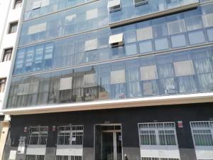 a tall building with a lot of windows at Departamentos Céntricos en Lima in Lima