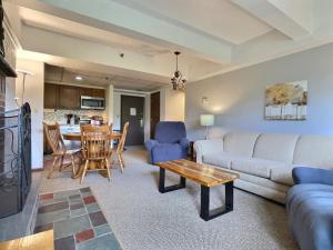 a living room with a couch and a table at LilBear- AC, Pool, Sauna, Hot Tub, Near Resort in Killington