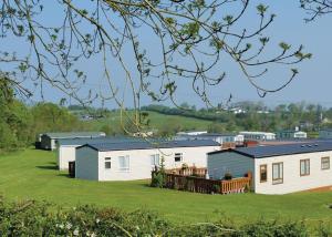 a row of cottages on a grassy field at Crofthead in Ayr