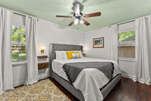 a bedroom with a bed and a ceiling fan at Quiet East Memphis Duplex The Green House in Memphis