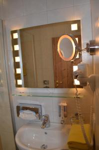 a bathroom with a sink and a mirror at Alpchalet Schwanstein in Halblech